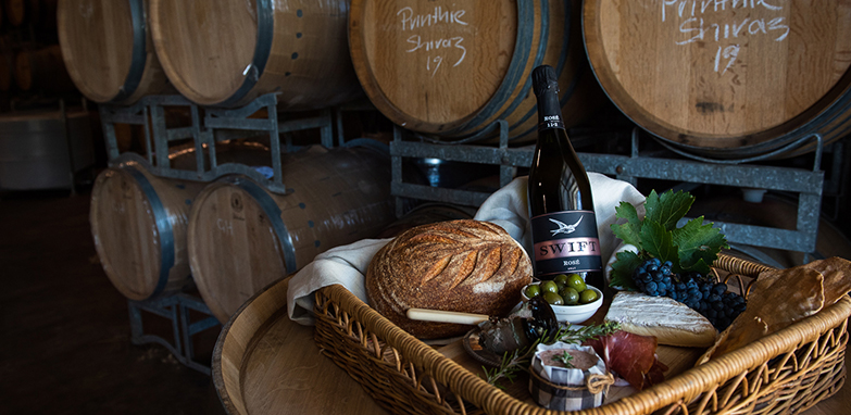 Wine and grazing platter situated amongst barrels at the Printhe winery and cellar door in Orange